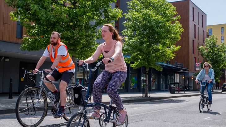 People on bikes cycling in a London street