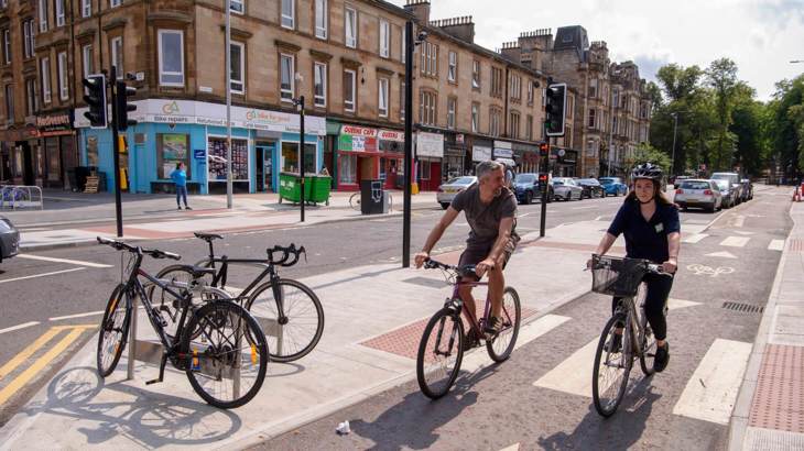 Two cyclists in a protected cycle lane