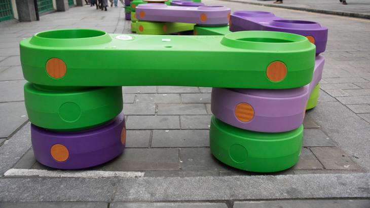 Green and orange plastic blocks on city street