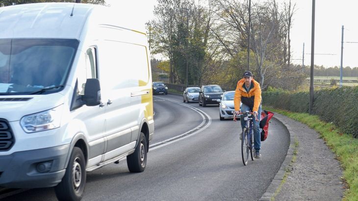 Cyclist on a busy road