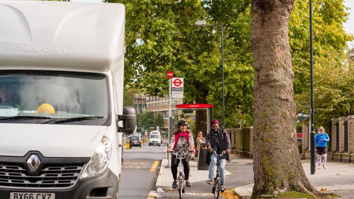 Two cyclists in a protected cycle lane in London