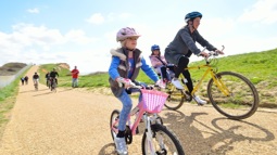 Mother and daughter cycling along a traffic-free National Cycle Network path