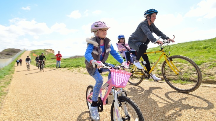 Mother and daughter cycling along a traffic-free National Cycle Network path