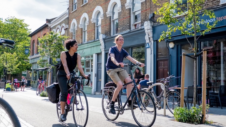 Male and female coworkers cycling side by side