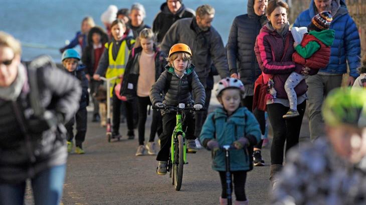 People cycling, walking and scooting to school