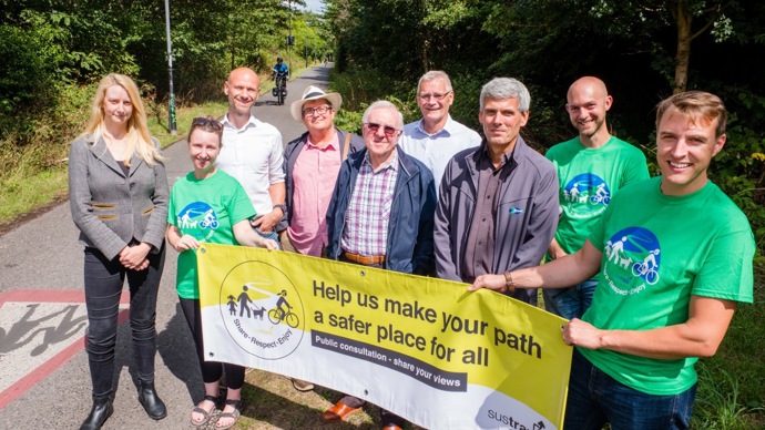 Walk Wheel Cycle Trust staff pose with local residents by the side of the Bristol and Bath Railway Path, holding a public consultation banner.