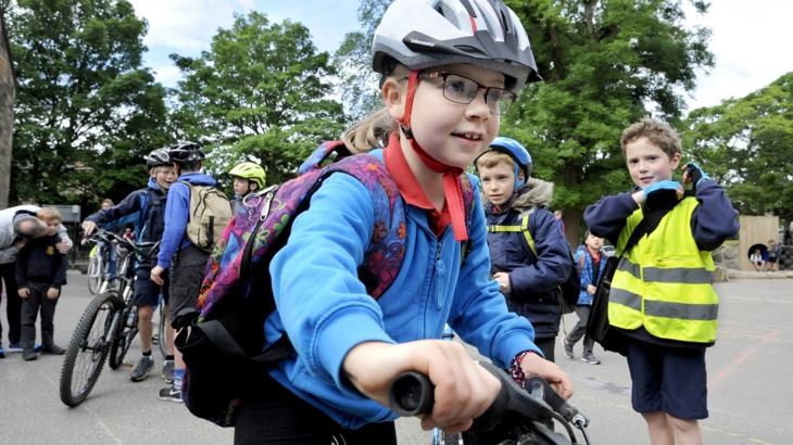 girl parking her bike at school