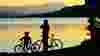 Silhouette of child and adult with bikes