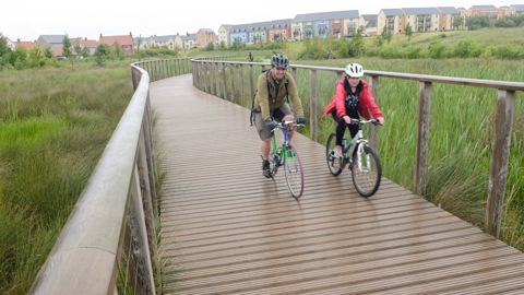 people on bikes near new housing development