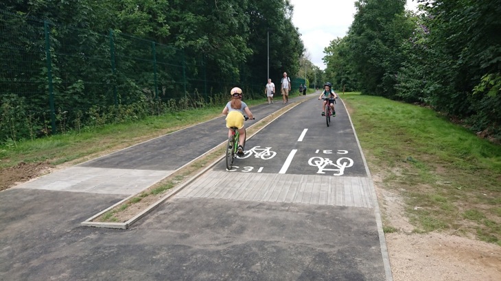 A picture children cycling on the Kingston and Merton path after work was completed