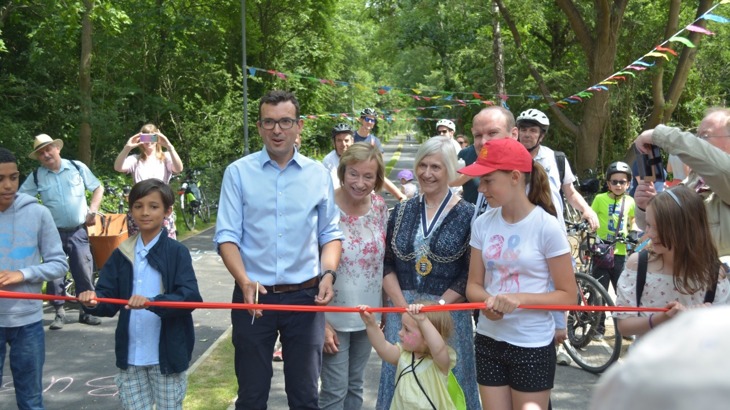 Will Norman cuts the ribbon to open the new bike path