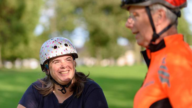 Smiling woman with bike helmet on