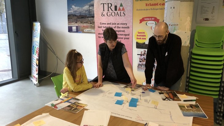 People stand around a table at a Collaborative Design Workshops For The Ripple Greenway Design