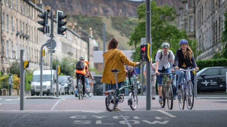 A Woman Standing At Some Traffic Lights In Edinburgh