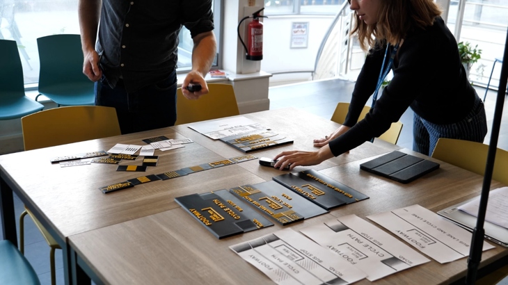 Researchers setting up tactile 3D printed models on a table for a study.