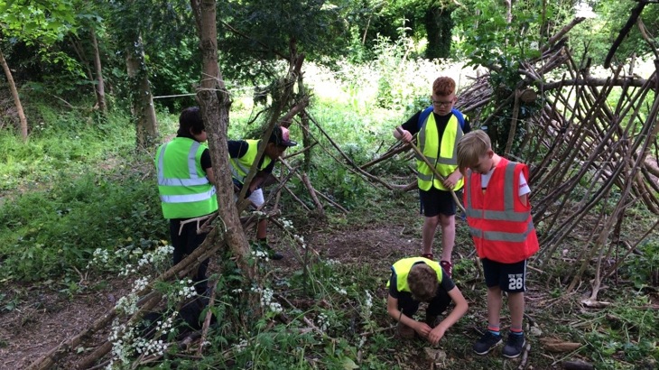 Children building dens in woods