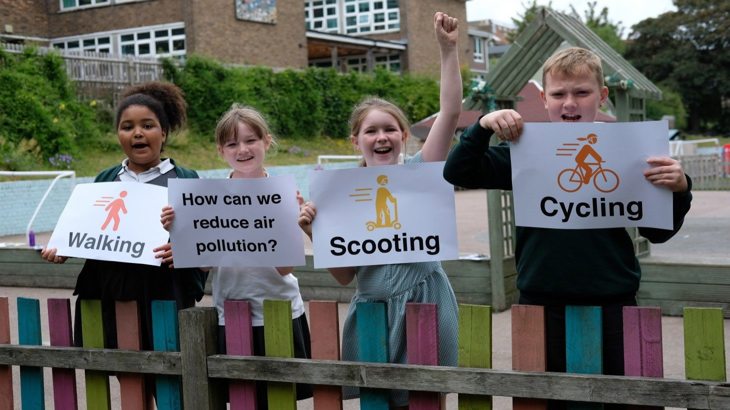school children holding signs for air quality project 