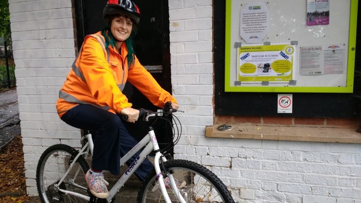 Flo Bass, a Nottingham-based jobseeker, sits on her bike 