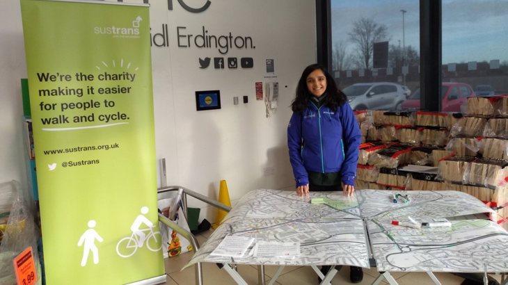 woman behind table with map on it next to Walk Wheel Cycle Trust banner