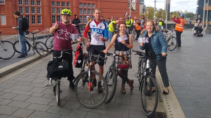 Members of the public at Cycle on the Snedd posing with 20 pound notes