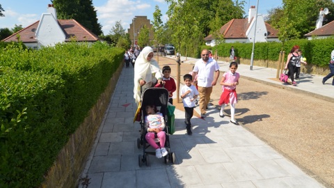 A family walk happily through a traffic free street