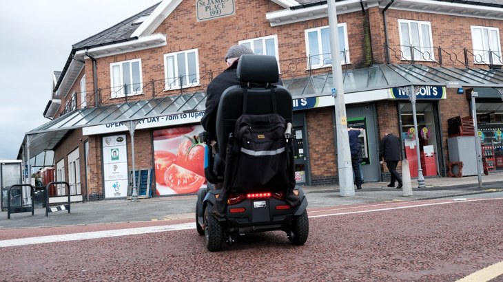 man in mobility scooter on the street