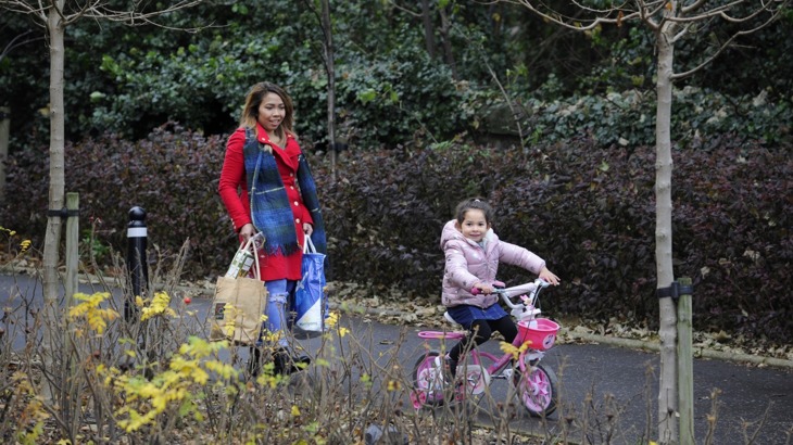 A mother and her daughter use a traffic-free cycle path for a shopping trip