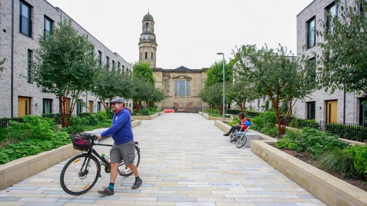 man with bike in public square - Salford Low Traffic Neighbourhood