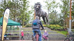 A man cycles through CS Lewis square in Belfast